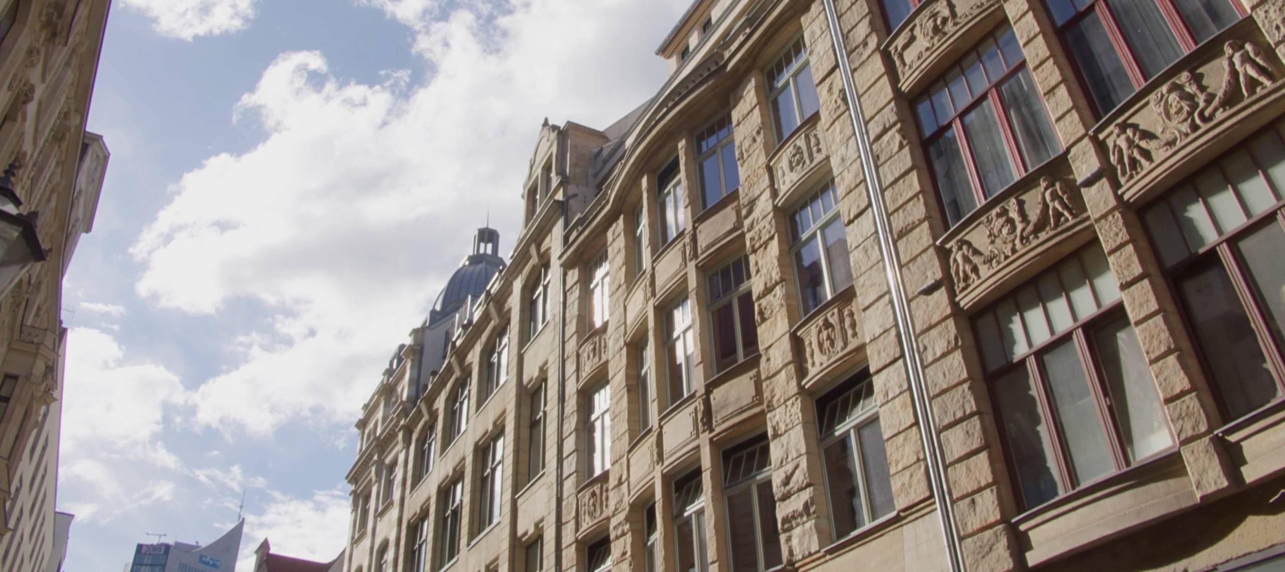 R42 Gebäede Außenansicht des R42 Gebäudes in der Ritterstraße 42 in Leipzig. Der Himmel ist leicht bewölkt, im Hintergrund zeichnet sich das City-Hochhaus ab.