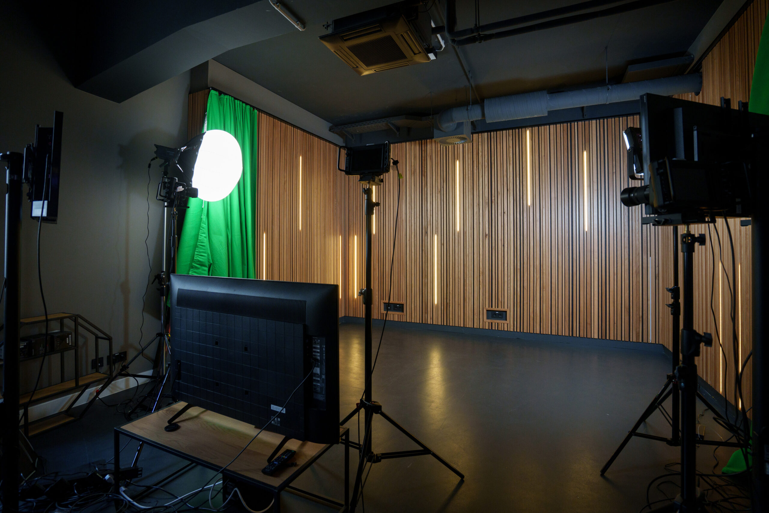 r42_studio_filmstudio-licht Filmstudio im R42 mit Filmequipment und Greenscreen im Hintergrund.